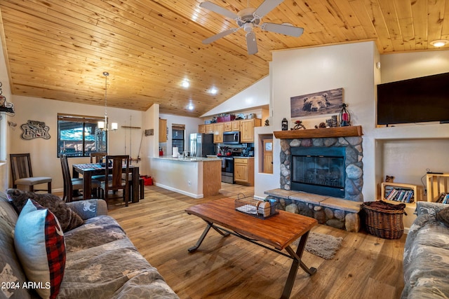 living room with wood ceiling, a stone fireplace, ceiling fan, and light hardwood / wood-style floors