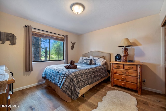 bedroom with hardwood / wood-style floors