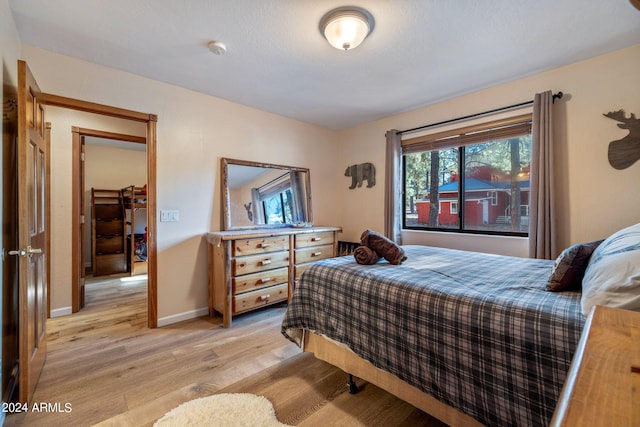 bedroom with light wood-type flooring