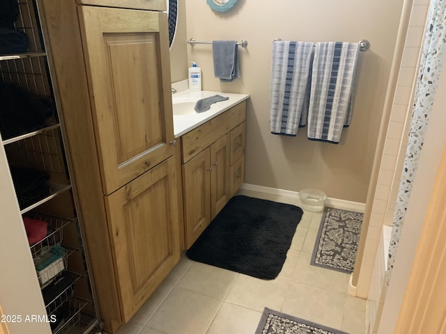 bathroom with shower / tub combo, vanity, and tile patterned flooring