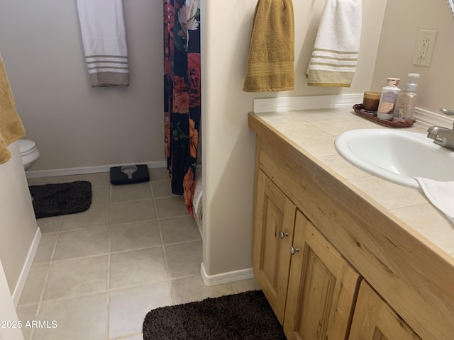 bathroom featuring tile patterned floors, toilet, and vanity