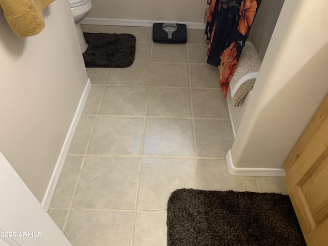 bathroom with tile patterned flooring and toilet