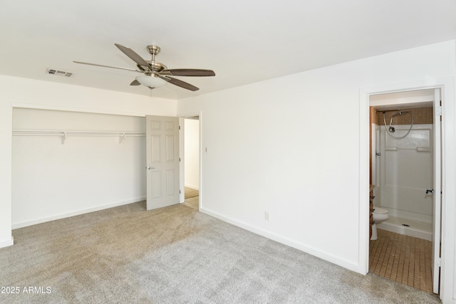 unfurnished bedroom with connected bathroom, light colored carpet, a closet, and ceiling fan