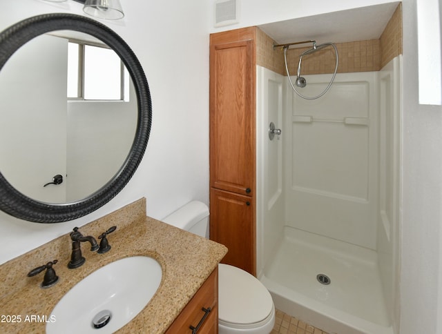 bathroom featuring walk in shower, vanity, and toilet