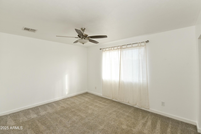 carpeted spare room featuring ceiling fan