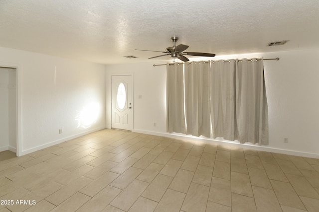 interior space featuring a textured ceiling, ceiling fan, and light hardwood / wood-style floors