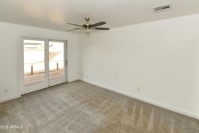 spare room featuring ceiling fan and carpet flooring