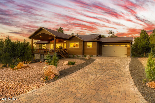 view of front of house featuring a porch and a garage