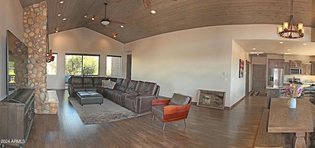 living room with ceiling fan with notable chandelier, dark hardwood / wood-style floors, and high vaulted ceiling