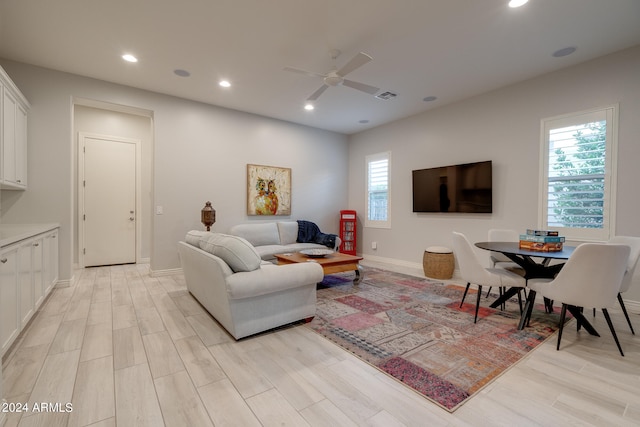 living room featuring light wood-type flooring and ceiling fan