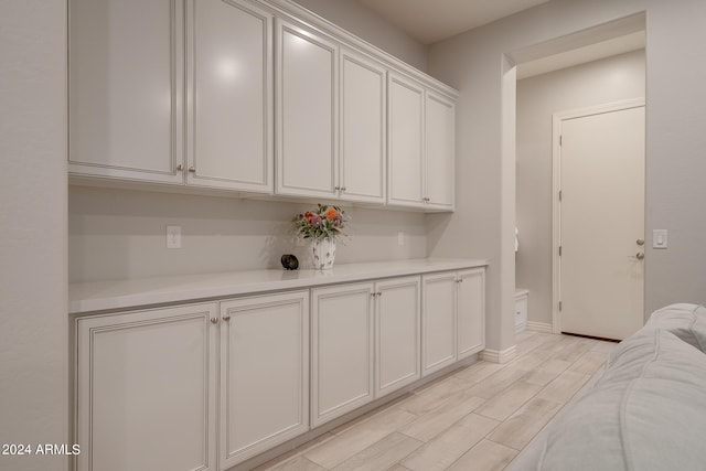 interior space featuring light hardwood / wood-style flooring and white cabinets