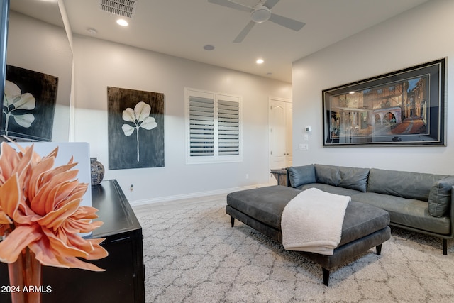 carpeted living room with ceiling fan