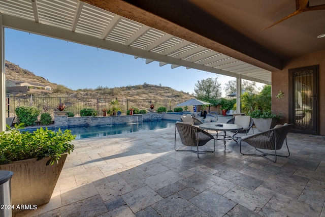 view of patio / terrace featuring a mountain view and a fenced in pool