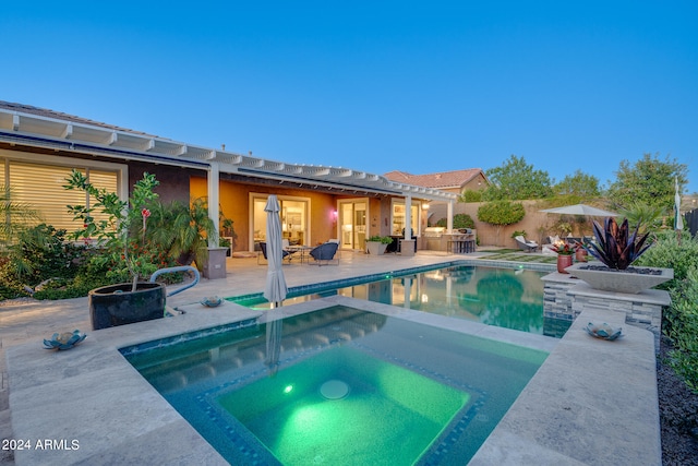 view of pool with a patio area and an in ground hot tub