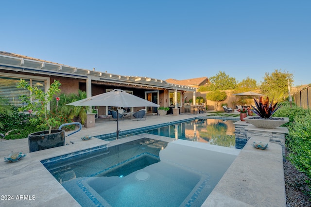 view of pool featuring a patio area and an in ground hot tub