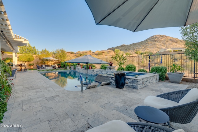 view of swimming pool featuring a mountain view and a patio