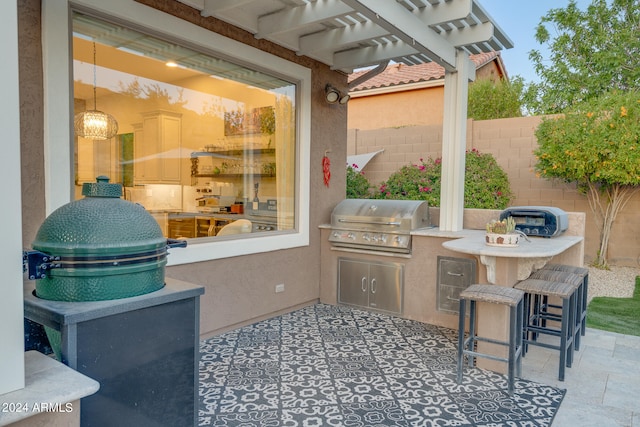 view of patio / terrace with exterior bar, a grill, a pergola, and area for grilling