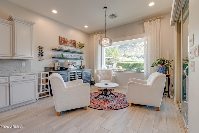 living room featuring light hardwood / wood-style flooring and a notable chandelier