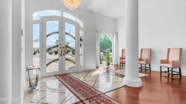 3126 E Fruitvale Ct, Gilbert, AZ 85297 - entrance foyer with french doors, a high ceiling, ornate columns, baseboards, and a chandelier