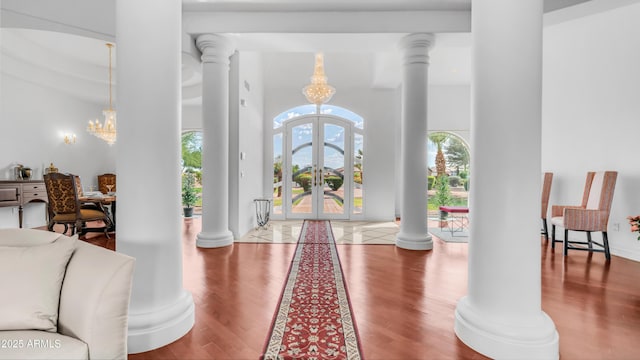 3126 E Fruitvale Ct, Gilbert, AZ 85297 - entrance foyer featuring wood finished floors, a chandelier, decorative columns, french doors, and a high ceiling