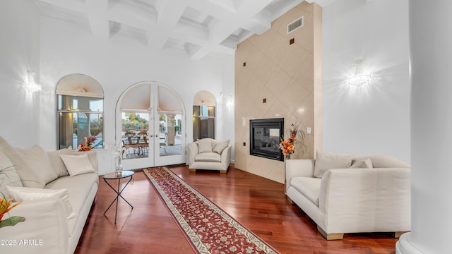 3126 E Fruitvale Ct, Gilbert, AZ 85297 - living room featuring a towering ceiling, beam ceiling, wood finished floors, coffered ceiling, and french doors