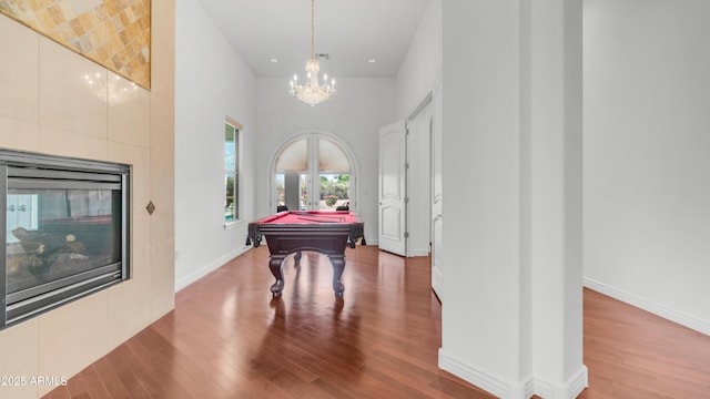 3126 E Fruitvale Ct, Gilbert, AZ 85297 - playroom with billiards table, wood finished floors, a towering ceiling, baseboards, and a chandelier