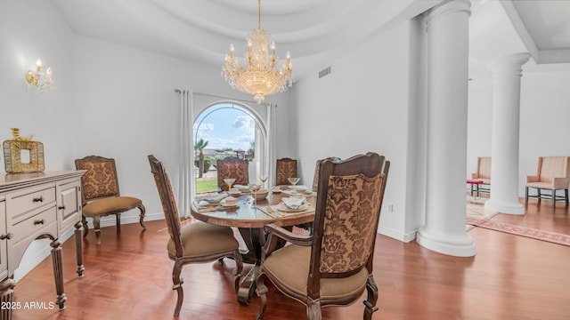 3126 E Fruitvale Ct, Gilbert, AZ 85297 - dining area featuring decorative columns, wood finished floors, and a chandelier