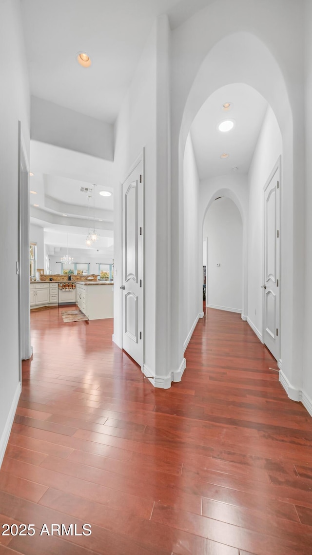 3126 E Fruitvale Ct, Gilbert, AZ 85297 - hallway featuring arched walkways, wood-type flooring, recessed lighting, and baseboards