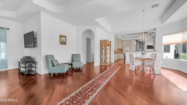 3126 E Fruitvale Ct, Gilbert, AZ 85297 - living area with a tray ceiling, arched walkways, wood finished floors, a chandelier, and baseboards