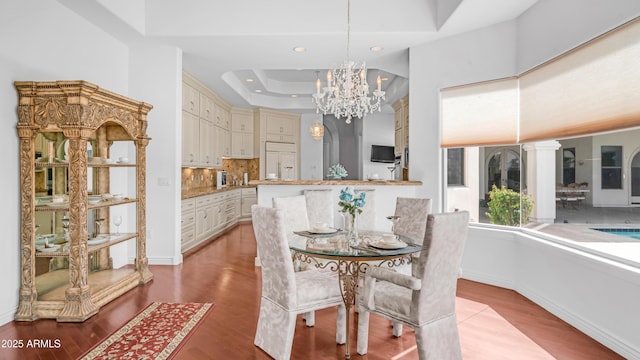 3126 E Fruitvale Ct, Gilbert, AZ 85297 - dining room featuring wood finished floors, a chandelier, a tray ceiling, recessed lighting, and baseboards