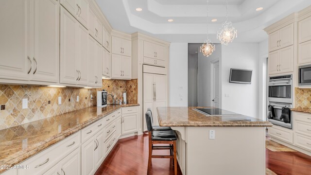 3126 E Fruitvale Ct, Gilbert, AZ 85297 - kitchen featuring recessed lighting, black appliances, dark wood-type flooring, a kitchen island, and decorative backsplash