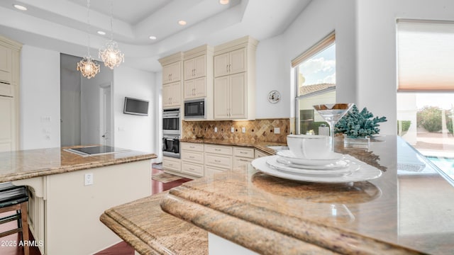3126 E Fruitvale Ct, Gilbert, AZ 85297 - kitchen with recessed lighting, black appliances, tasteful backsplash, light stone counters, and decorative light fixtures