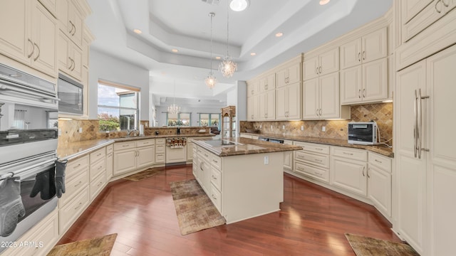 3126 E Fruitvale Ct, Gilbert, AZ 85297 - kitchen with a peninsula, a chandelier, stainless steel double oven, dark wood-style floors, and recessed lighting