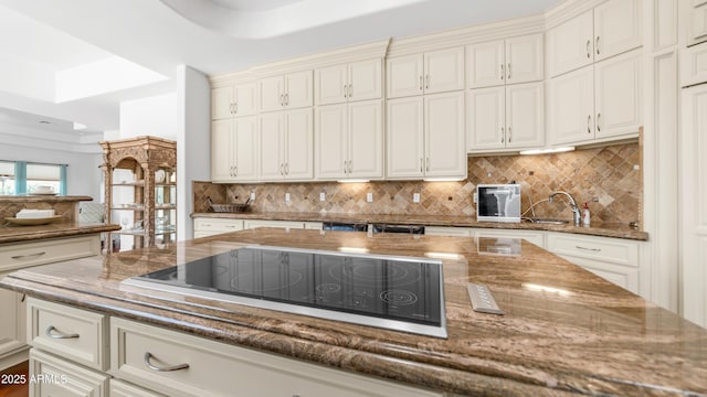 3126 E Fruitvale Ct, Gilbert, AZ 85297 - kitchen featuring black electric cooktop, backsplash, and dark stone countertops