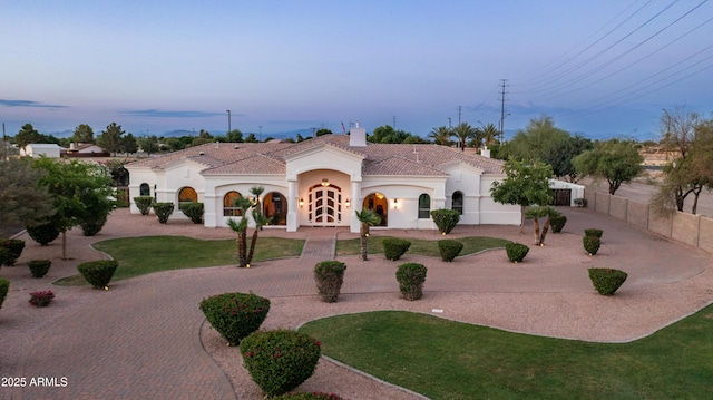 3126 E Fruitvale Ct, Gilbert, AZ 85297 - mediterranean / spanish house featuring curved driveway, a tiled roof, stucco siding, and a chimney