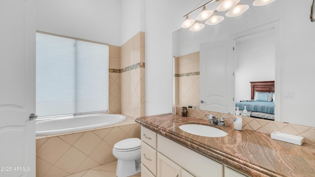 3126 E Fruitvale Ct, Gilbert, AZ 85297 - full bathroom with vanity, a relaxing tiled tub, toilet, ensuite bathroom, and tile patterned flooring