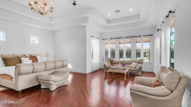 3126 E Fruitvale Ct, Gilbert, AZ 85297 - living room featuring a raised ceiling, healthy amount of natural light, wood finished floors, a chandelier, and recessed lighting