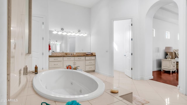 3126 E Fruitvale Ct, Gilbert, AZ 85297 - bathroom with vanity, a jetted tub, tile patterned flooring, and baseboards