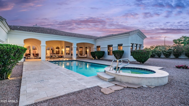 3126 E Fruitvale Ct, Gilbert, AZ 85297 - pool at dusk featuring a patio area, an in-ground hot tub, and an outdoor pool