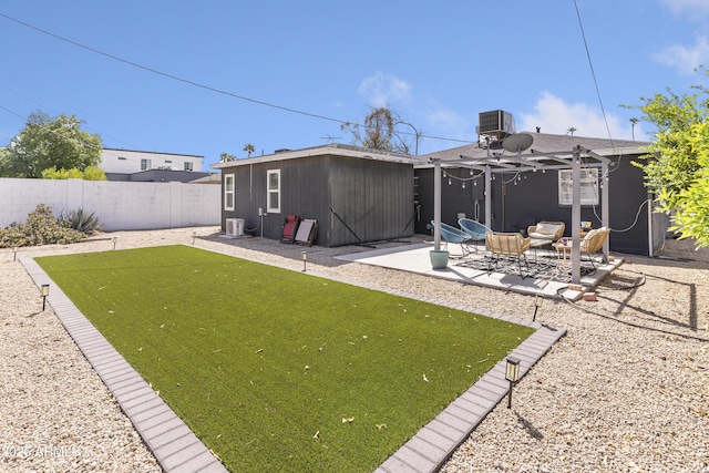 back of property featuring a patio area, fence, and an outbuilding
