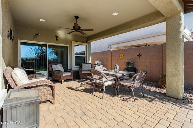 view of patio with ceiling fan and an outdoor living space