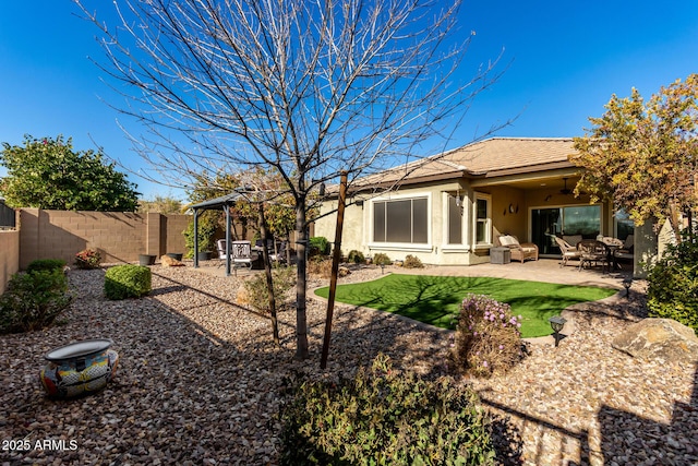 rear view of house with a patio area, a gazebo, and a lawn