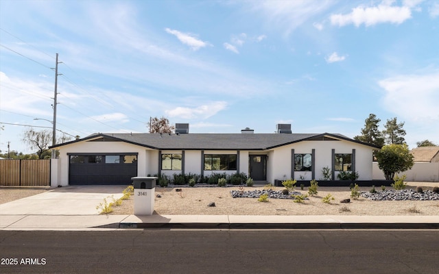 view of front facade with a garage and cooling unit