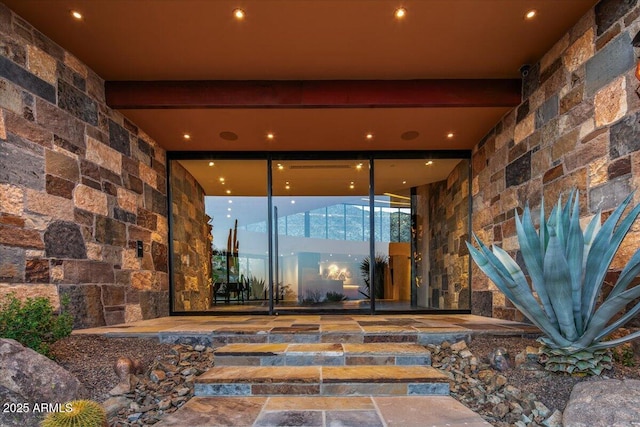 doorway to property featuring stone siding