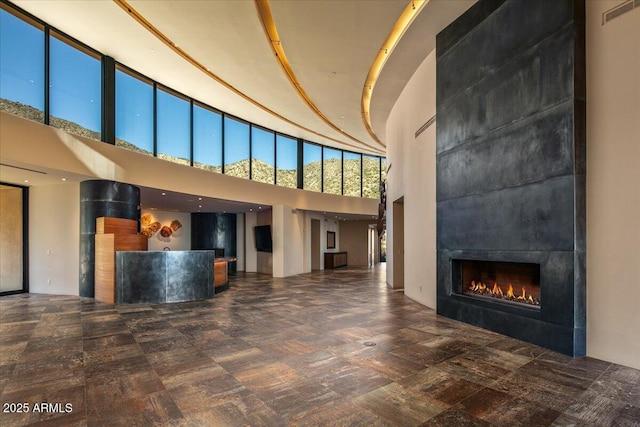 reception area featuring visible vents and a tile fireplace