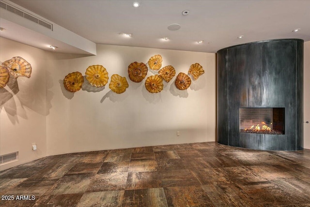 spare room featuring recessed lighting, a fireplace, and visible vents