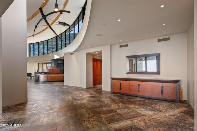 foyer with a high ceiling, a notable chandelier, visible vents, and recessed lighting