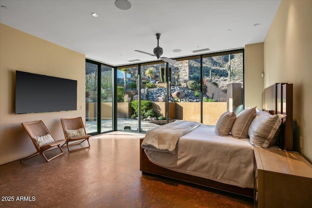 bedroom with finished concrete flooring, access to outside, and floor to ceiling windows
