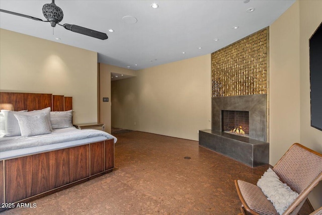 bedroom with a large fireplace and recessed lighting