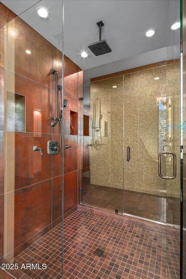 interior space with a shower stall, tile patterned flooring, and recessed lighting